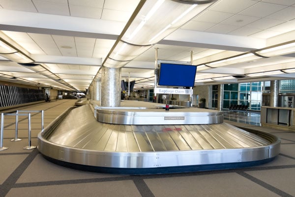 Image of a luggage carousel in an airport.